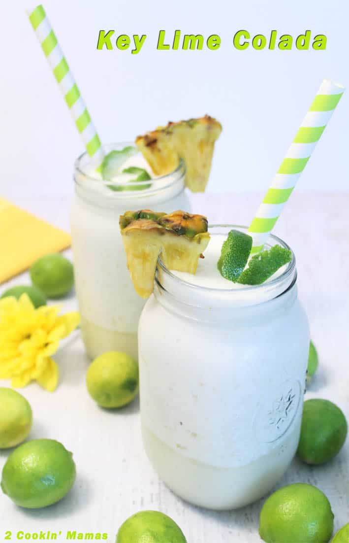 2 mason jars filled with key lime colada and garnished with lime twist, pineapple chunk and green and white striped straw.