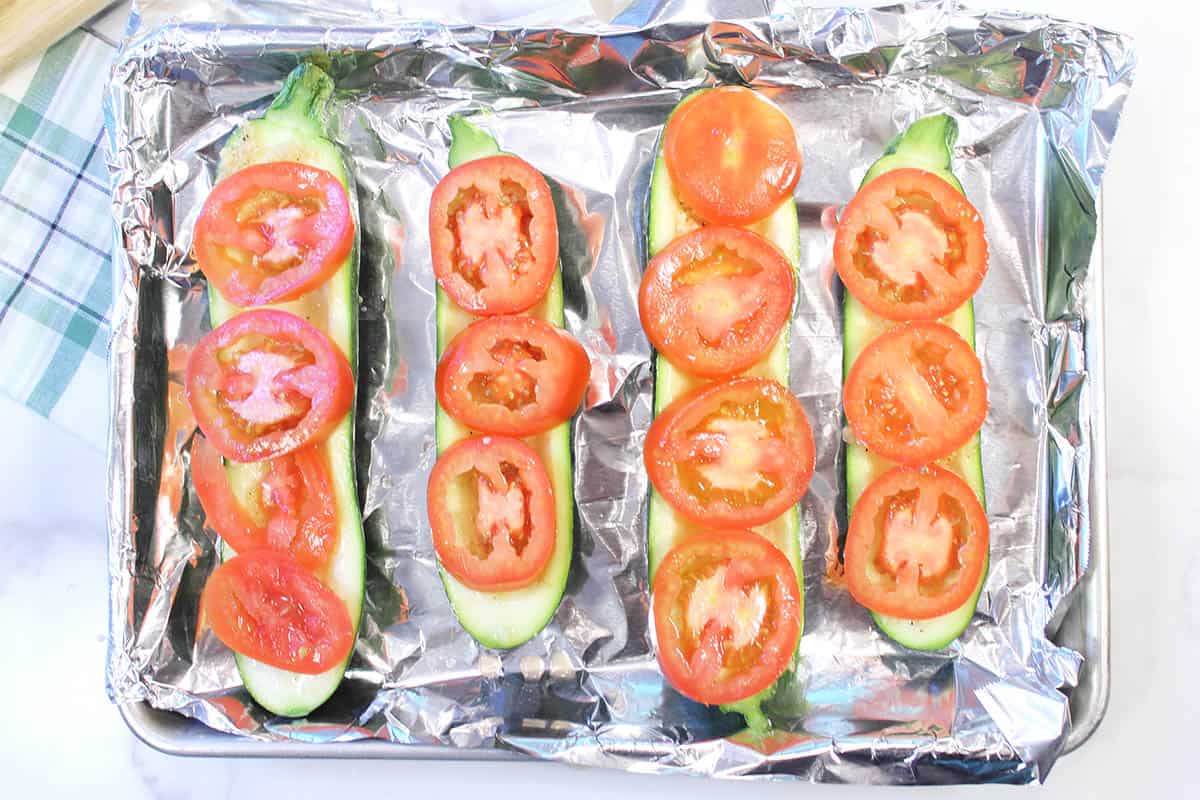 Layer of tomatoes on top of oiled zucchini.