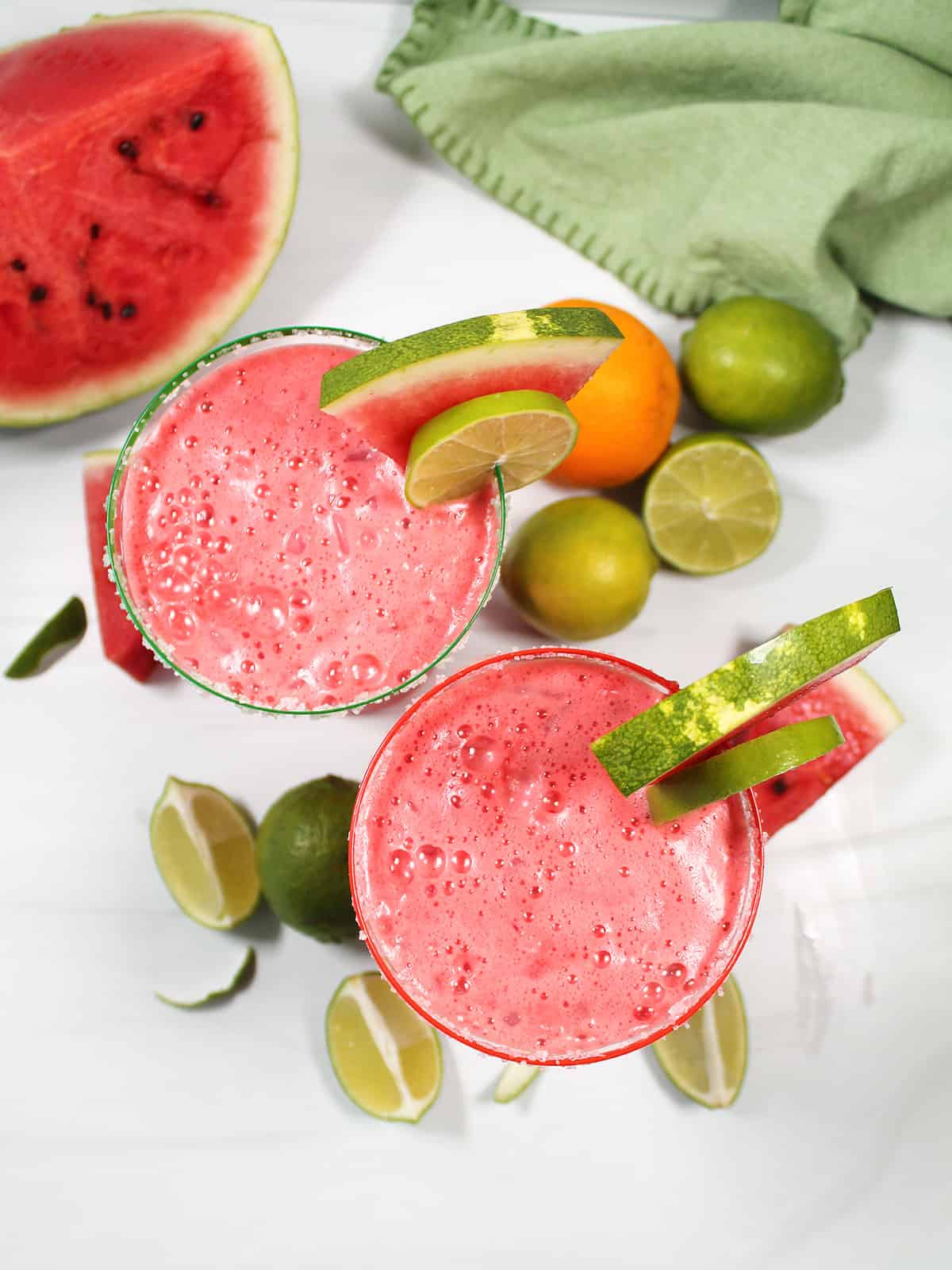 Overhead of two garnished margaritas.