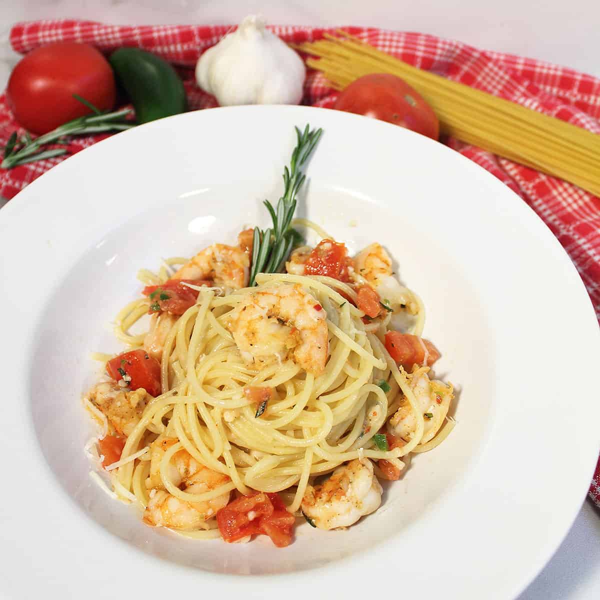 Rattlesnake Pasta in white bowl with ingredients in background