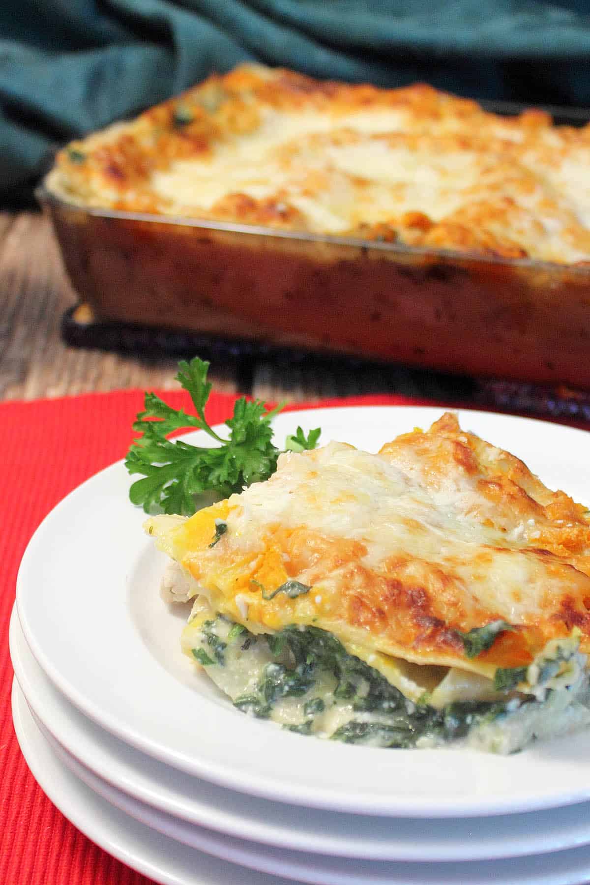 Showing serving on white plate in front with casserole in back.