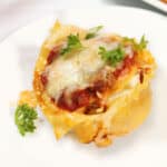 Closeup of single mini lasagna cup.