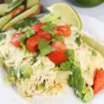 Plated chicken avocado enchiladas showing inside filling.