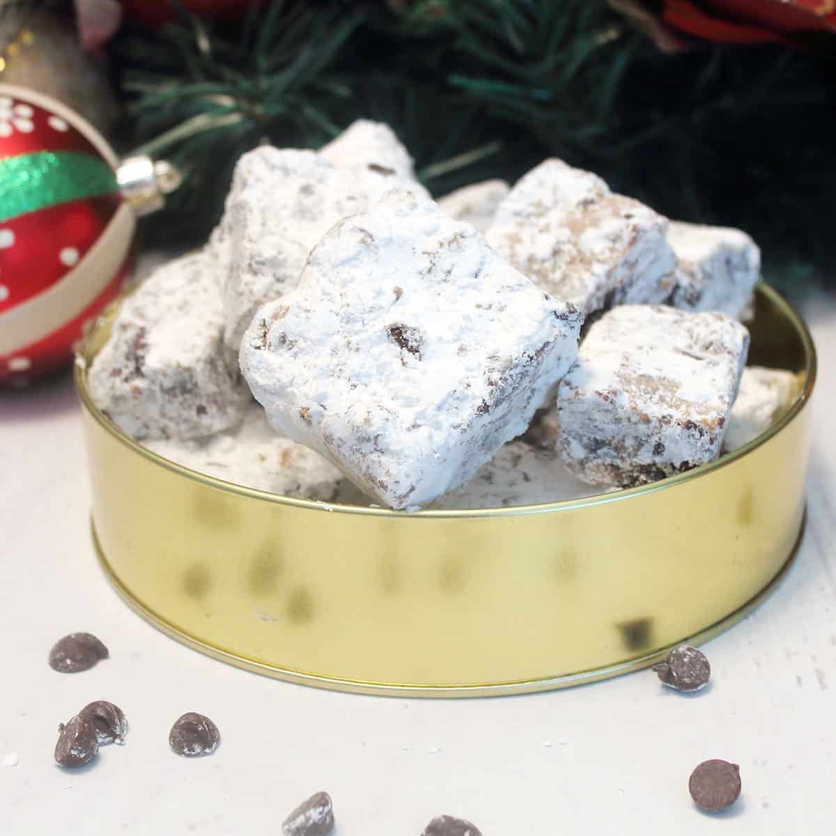 Chocolate chip cookie bars in Christmas cookie tin.
