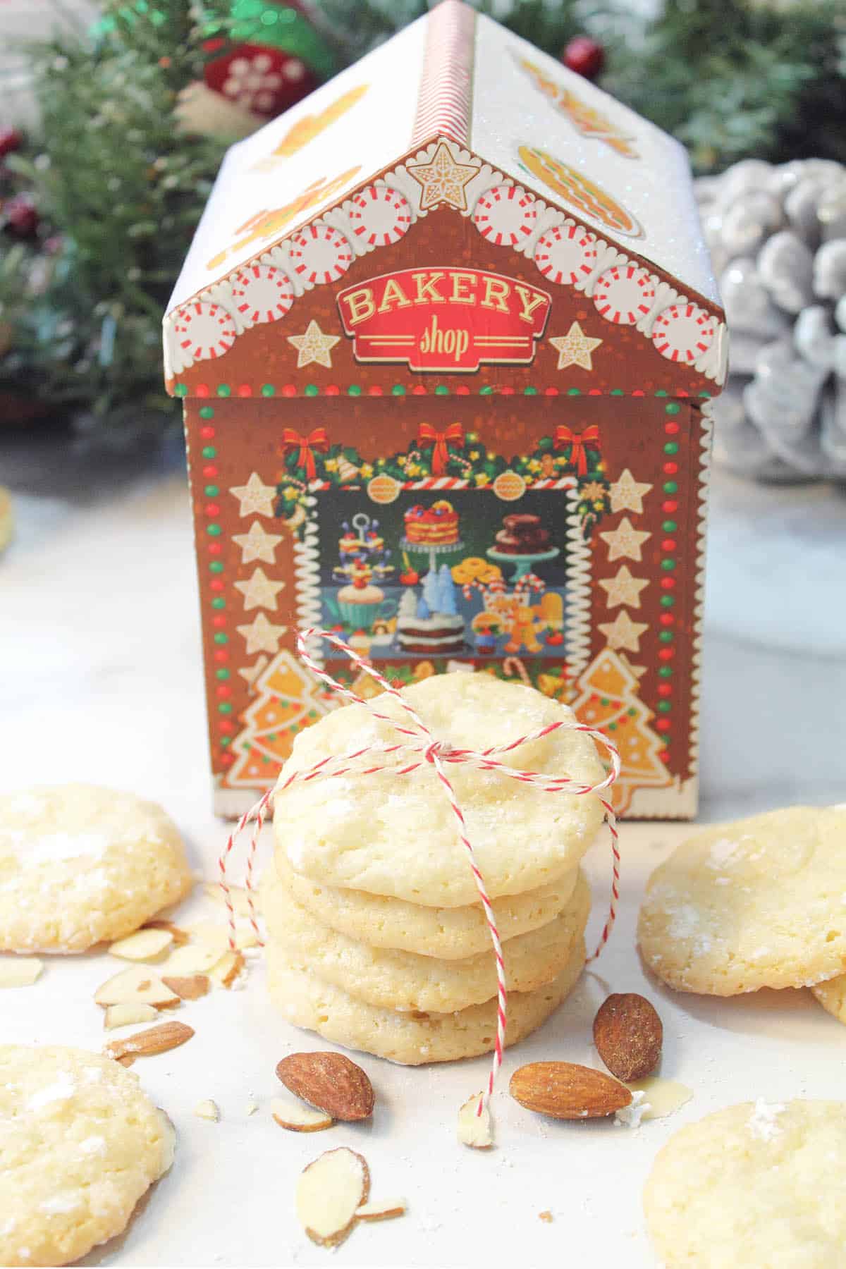 Gluten free almond cookies in front of small cookie box.