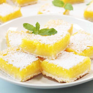 Plated gluten free lemon bars with mint garnish.