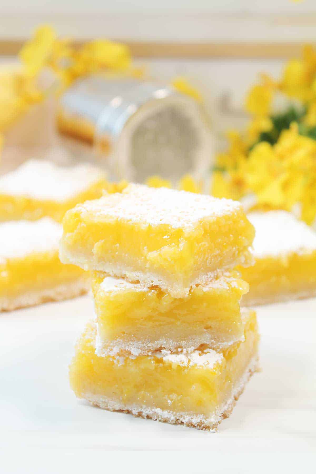 Stack of three gluten-free lemon bars.