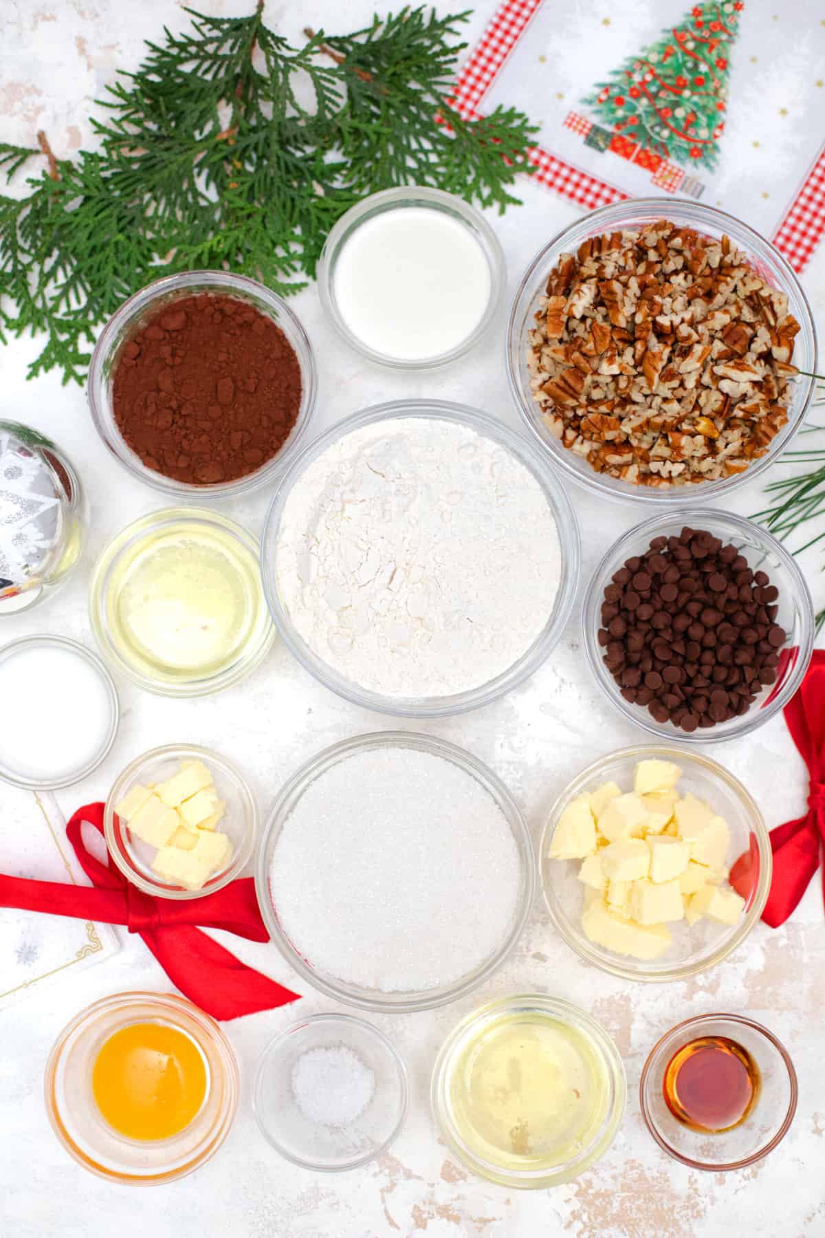 Ingredients laid out on white table for turtle cookies.