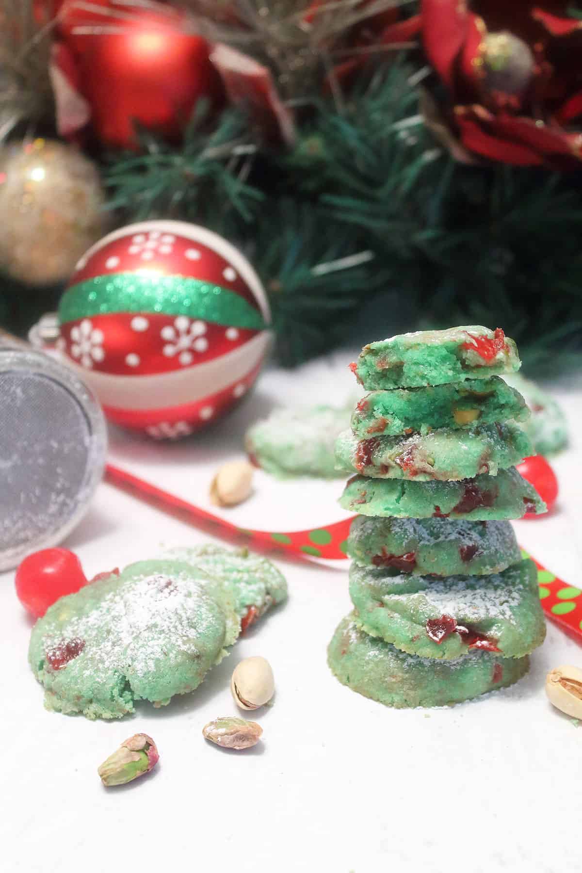 Stack of pistachio cookies with Christmas ornament.
