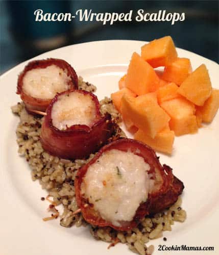 Cooked Bacon Wrapped Scallops on top of rice on white plate.