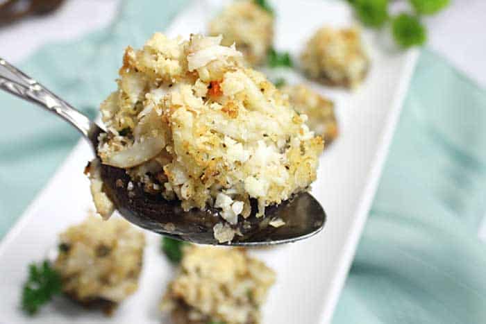 Crab Stuffed Mushroom on spoon showing browned top.