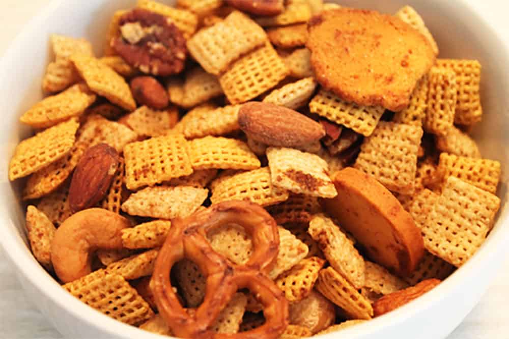 Closeup of Gluten Free Chex Mix in white bowl.