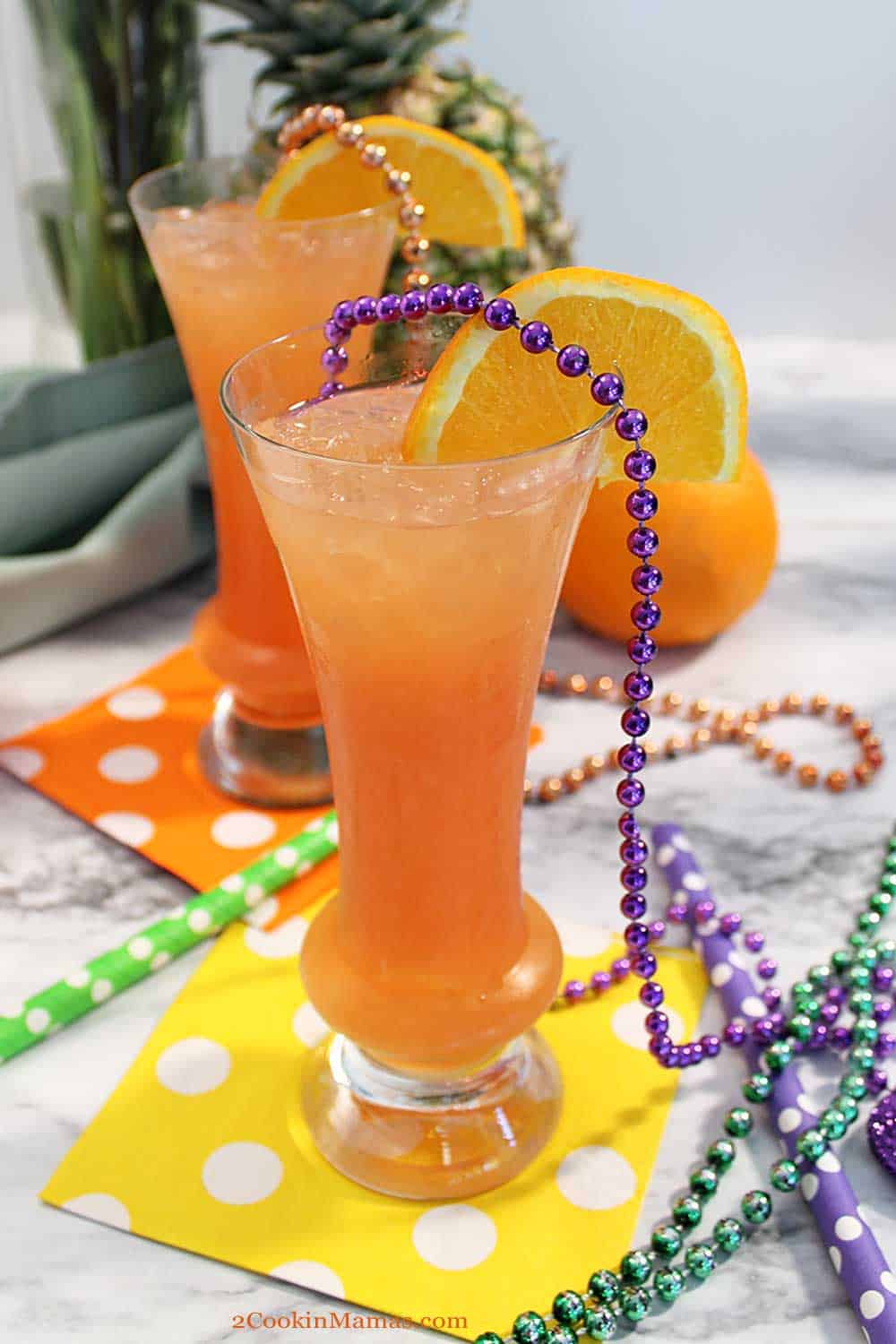 Hurricane Cocktail | 2 Cookin Mamas This tropical hurricane cocktail will transport you to a Caribbean island. Light & dark rum combine with orange & pineapple juices for a fresh fruity drink. #rumcocktail #MadriGras #tropicalcocktail #cocktail #fruitycocktail #drink #recipe #punch