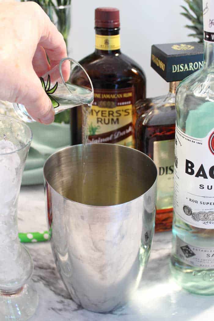 adding rum to cocktail