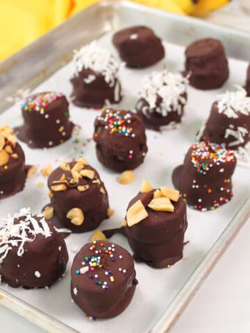 Frozen Chocolate Peanut Butter Banana Bites on baking sheet.