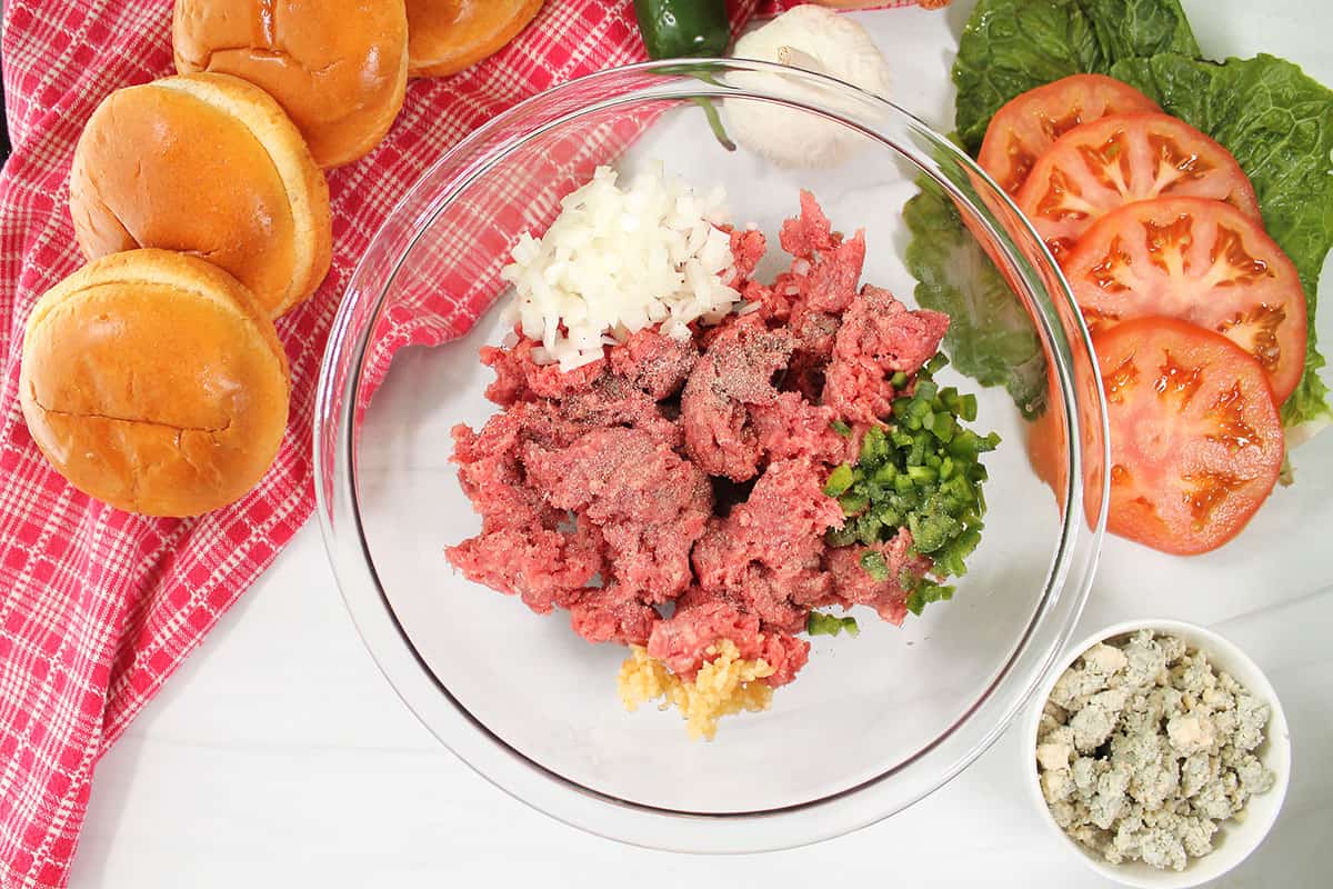 Mixing ingredients for bleu cheese burgers.