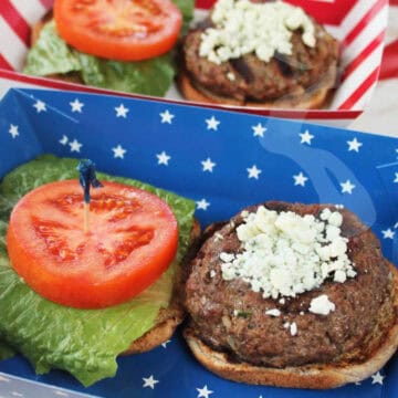 Blue Cheese Burgers on buns with lettuce and tomato.