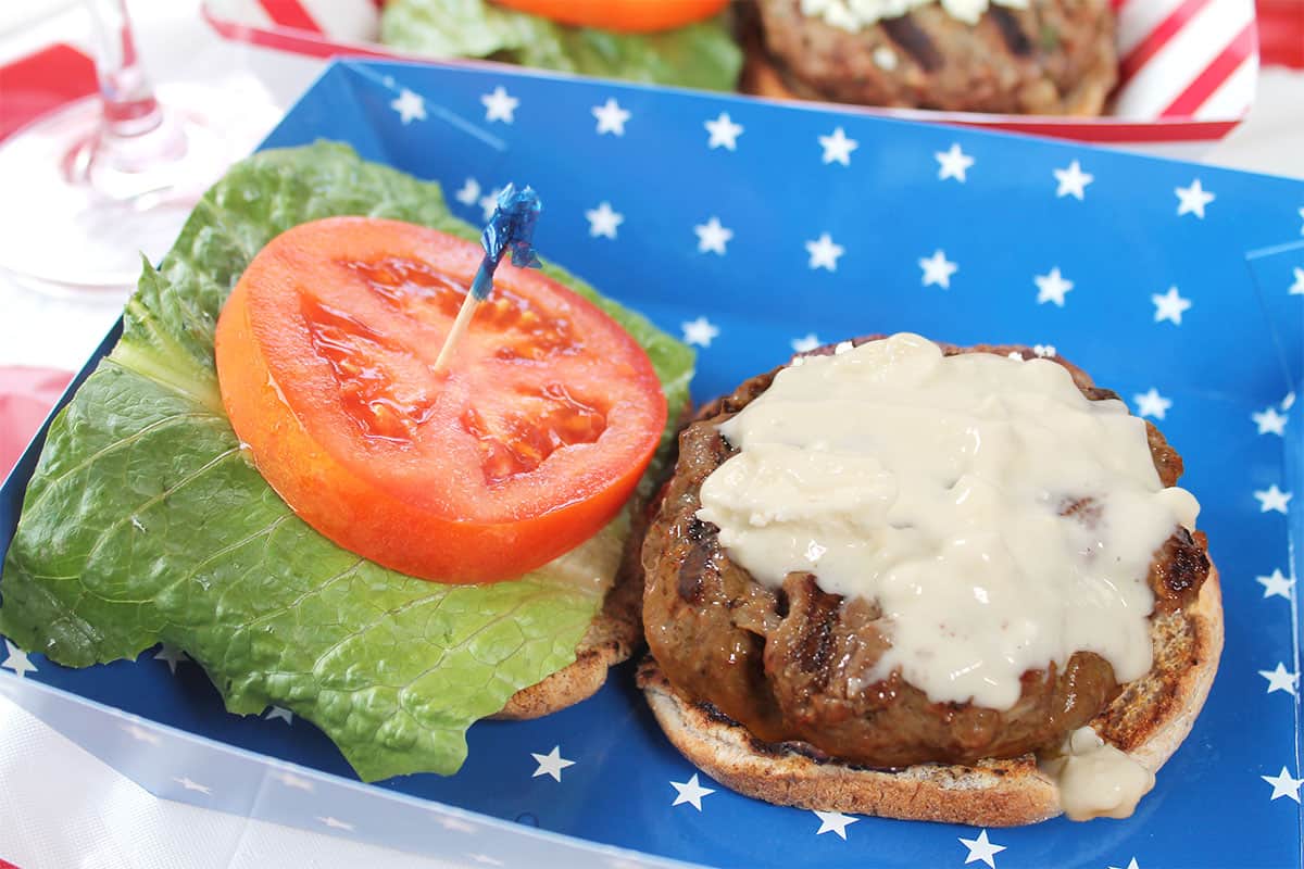 Blue Cheese Burger with fixings in patriotic basket.