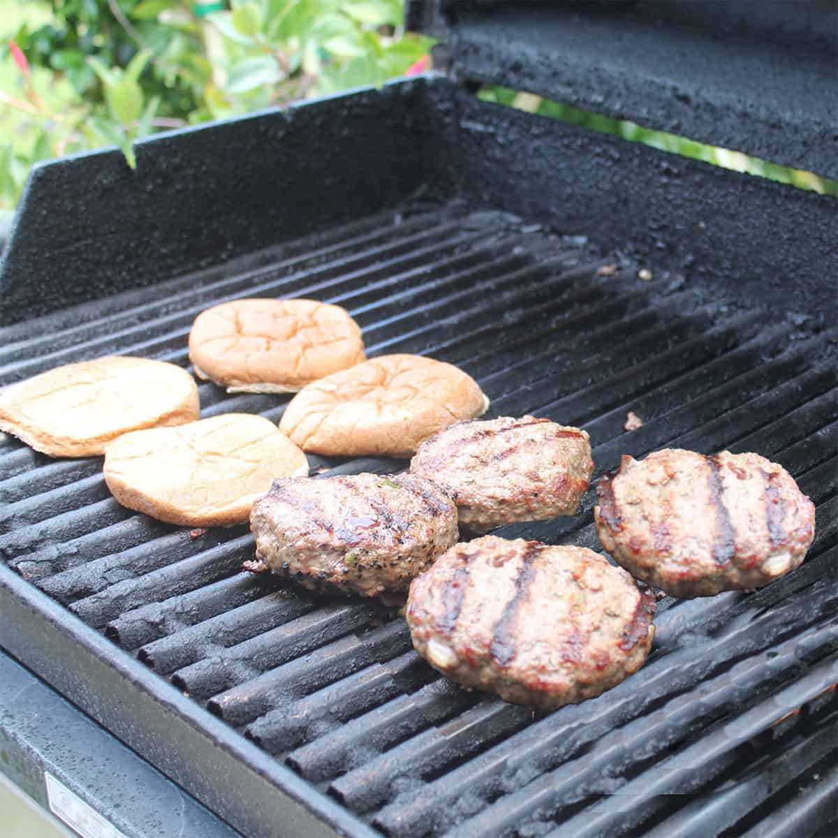 Blue cheese burgers on grill.