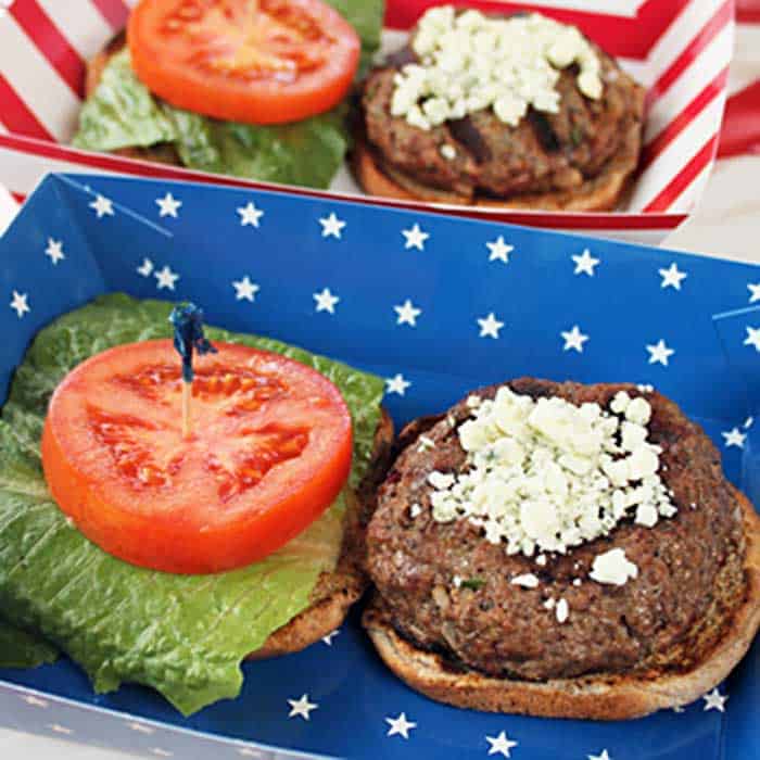 Closeup of burger with lettuce and tomato in a patriotic tray