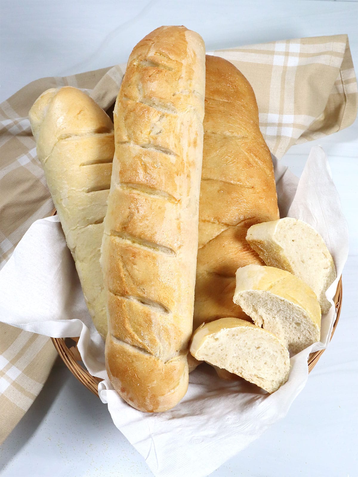 Three loaves homemade French Bread in basket.