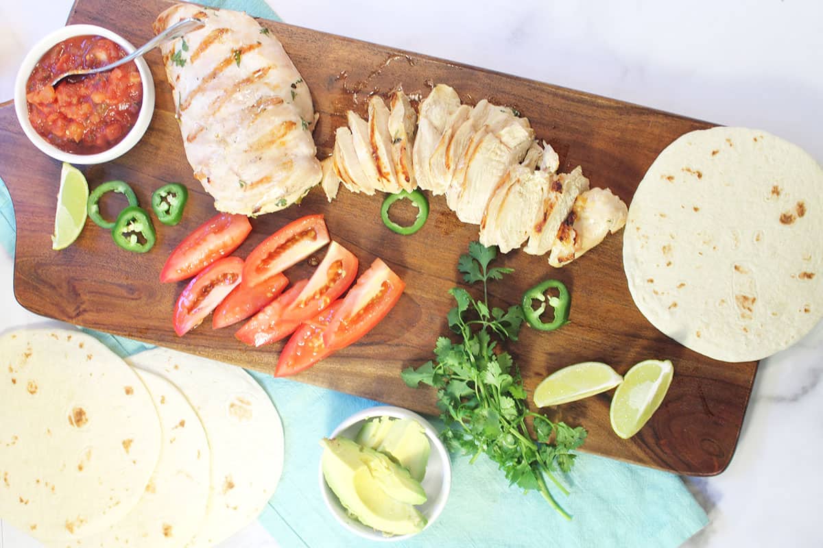 Overhead of tequila-marinated chicken with sides.