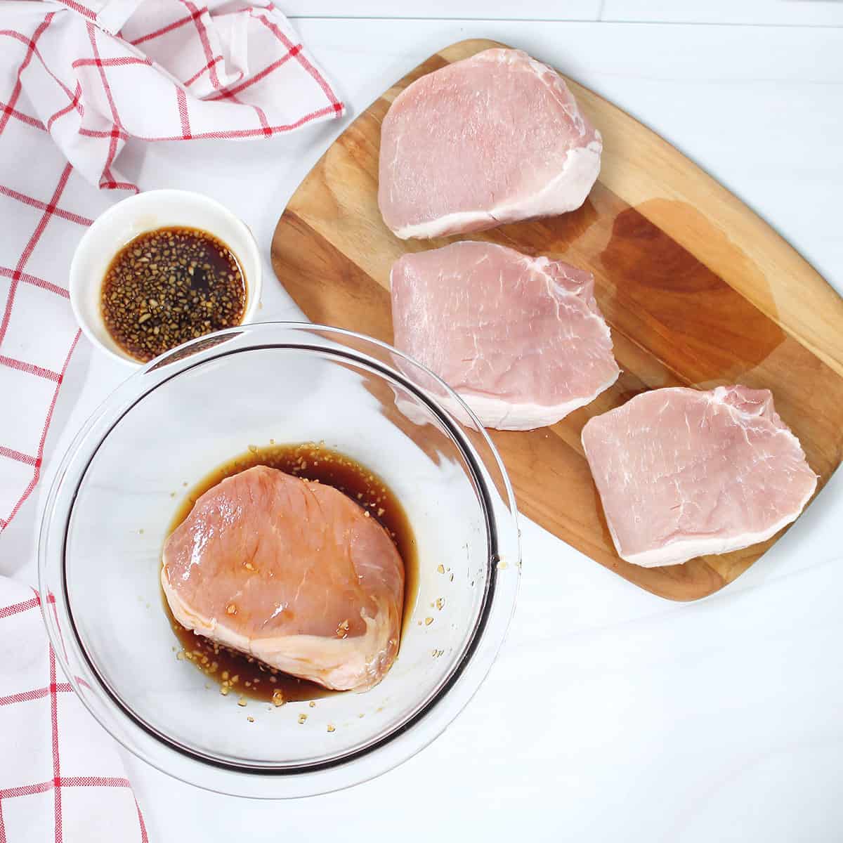 Coating pork chops with honey garlic marinade.