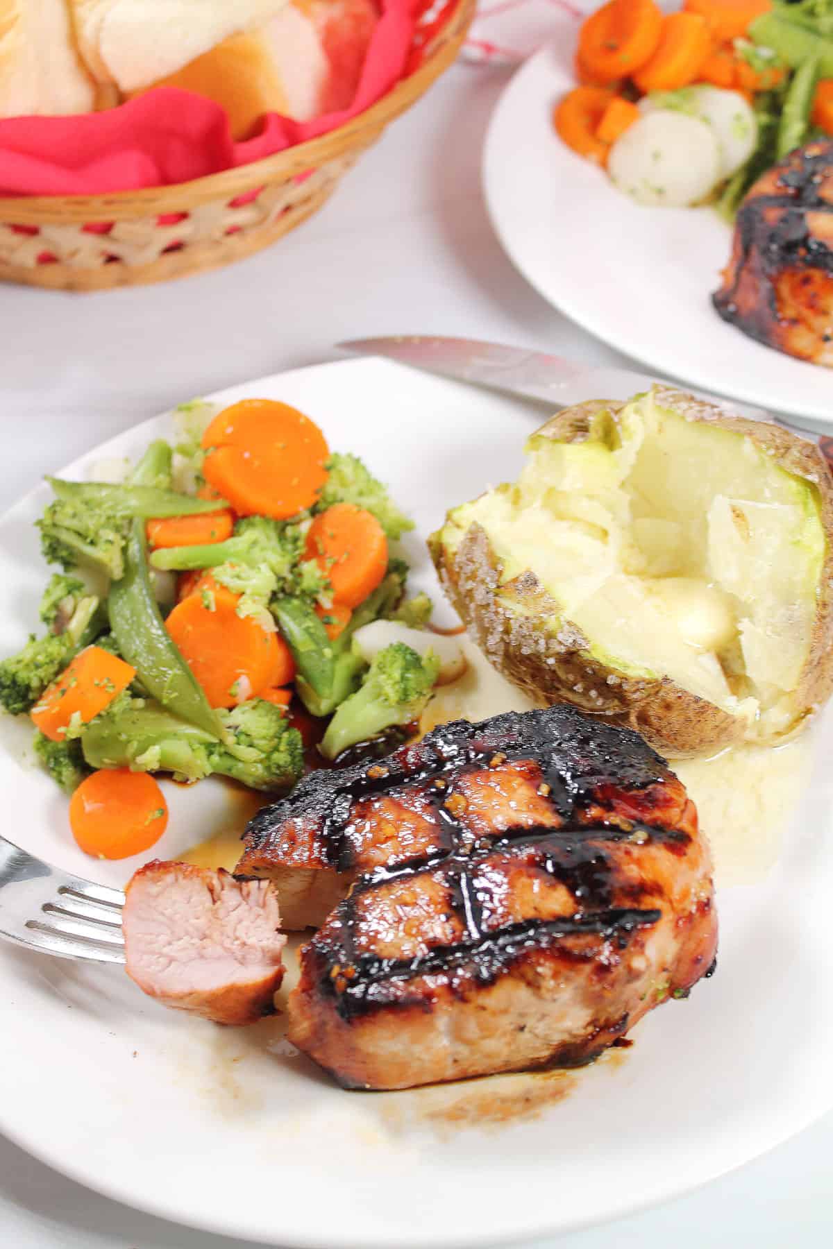 Plated grilled honey garlic pork chops dinner.