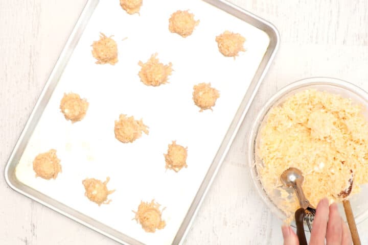 Coconut macaroon dough scooped onto cookie sheet.