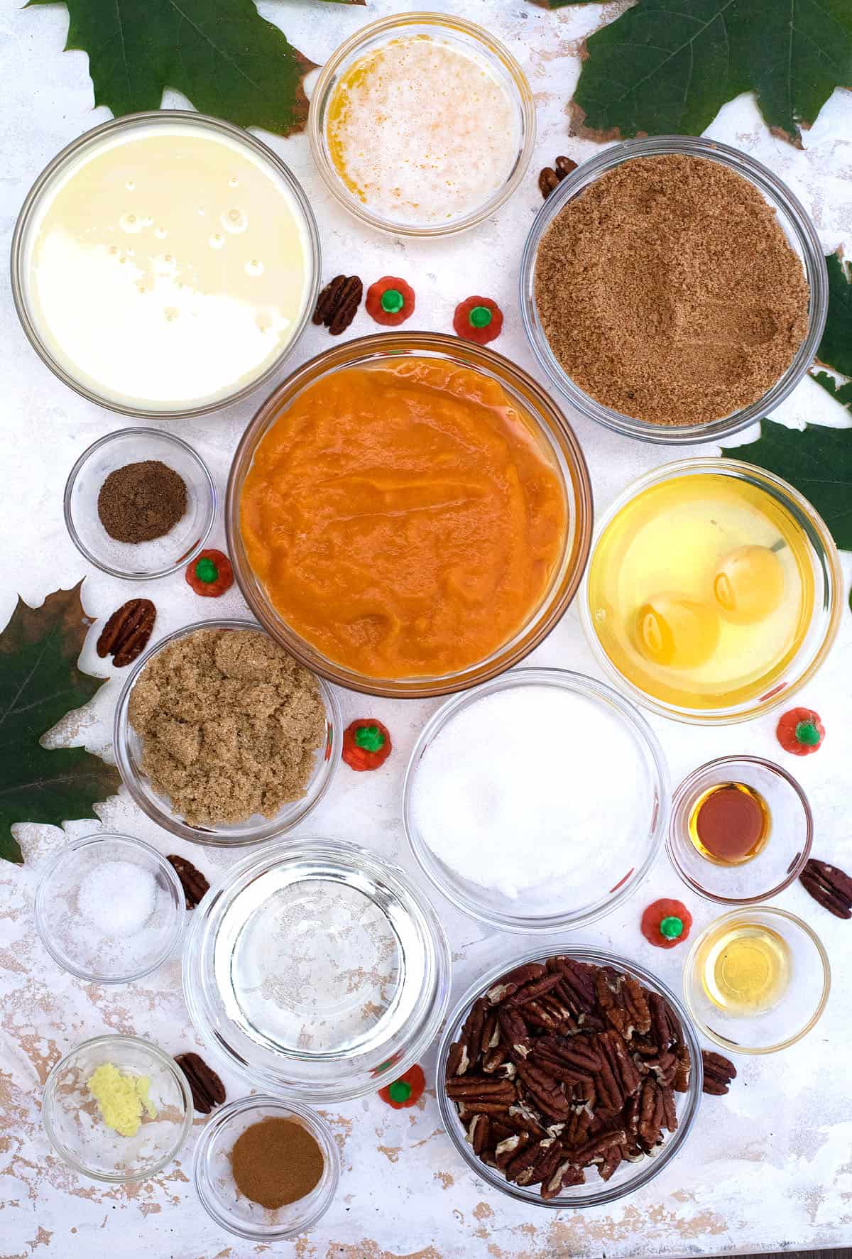 Pumpkin Pecan Pie ingredients on white marbled table.