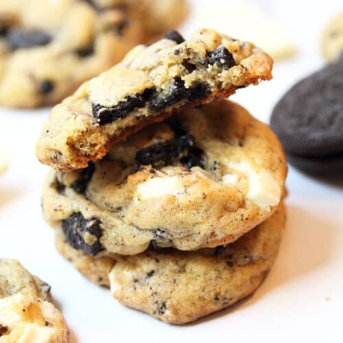 Stacked Oreo pudding cookies with bite taken out.