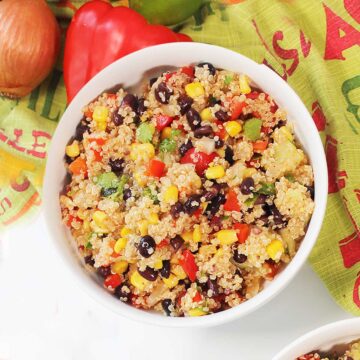 Overhead of black bean quinoa salad with corn by green towel.