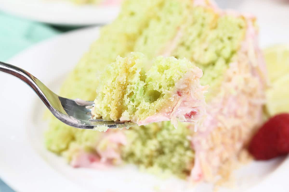 Bite of cake with lemon curd filling on fork.