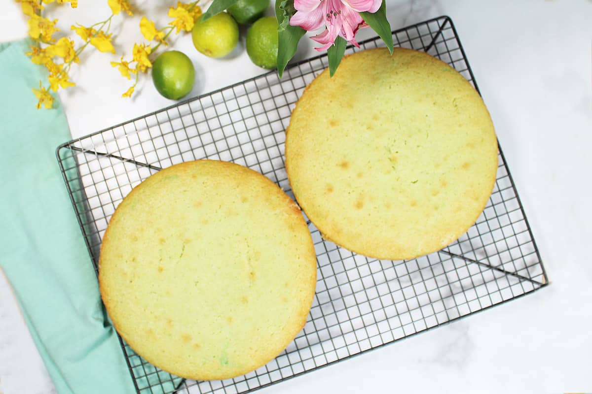 Key lime cake removed from pans and cooling on rack.