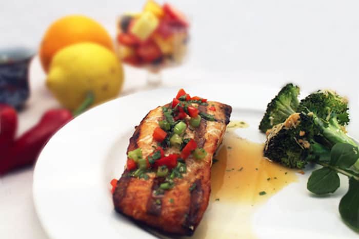 Grilled orange salmon and broccoli on a plate