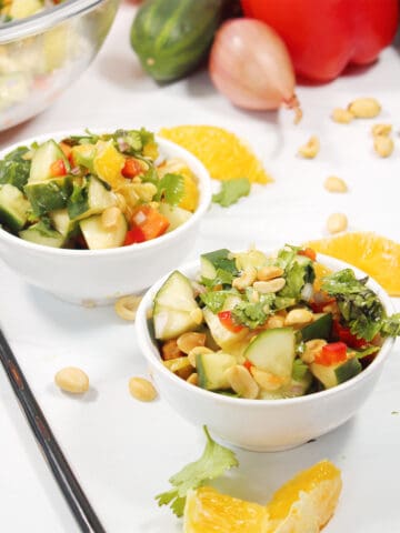 Two bowls of Thai Cucumber Salad with peanuts.