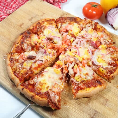 BBQ Pulled Pork Pizza on wooden cutting board.