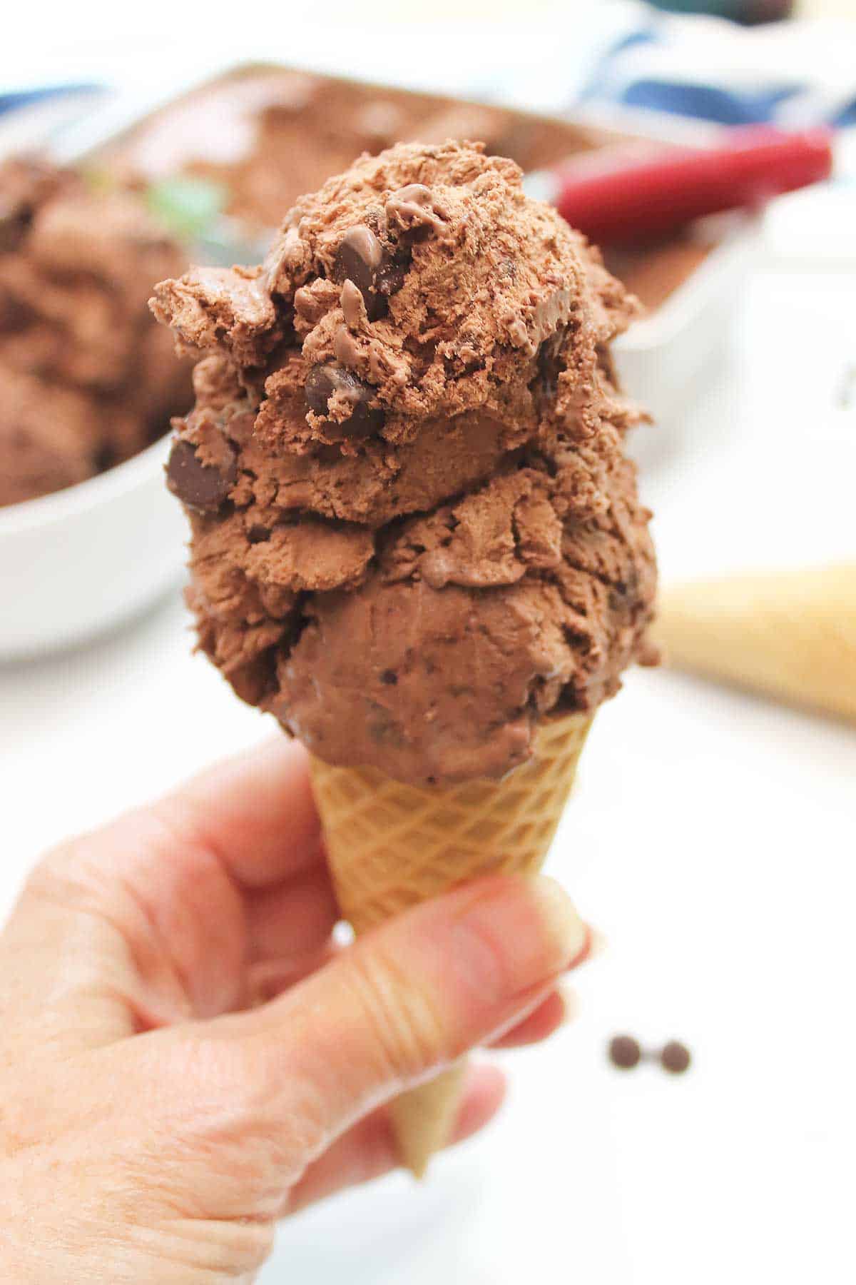 Double scoop of chocolate ice cream in a sugar cone.