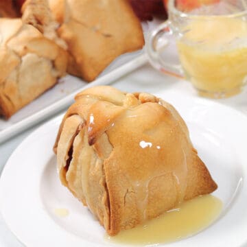 Closeup of apple dumpling with sauce.