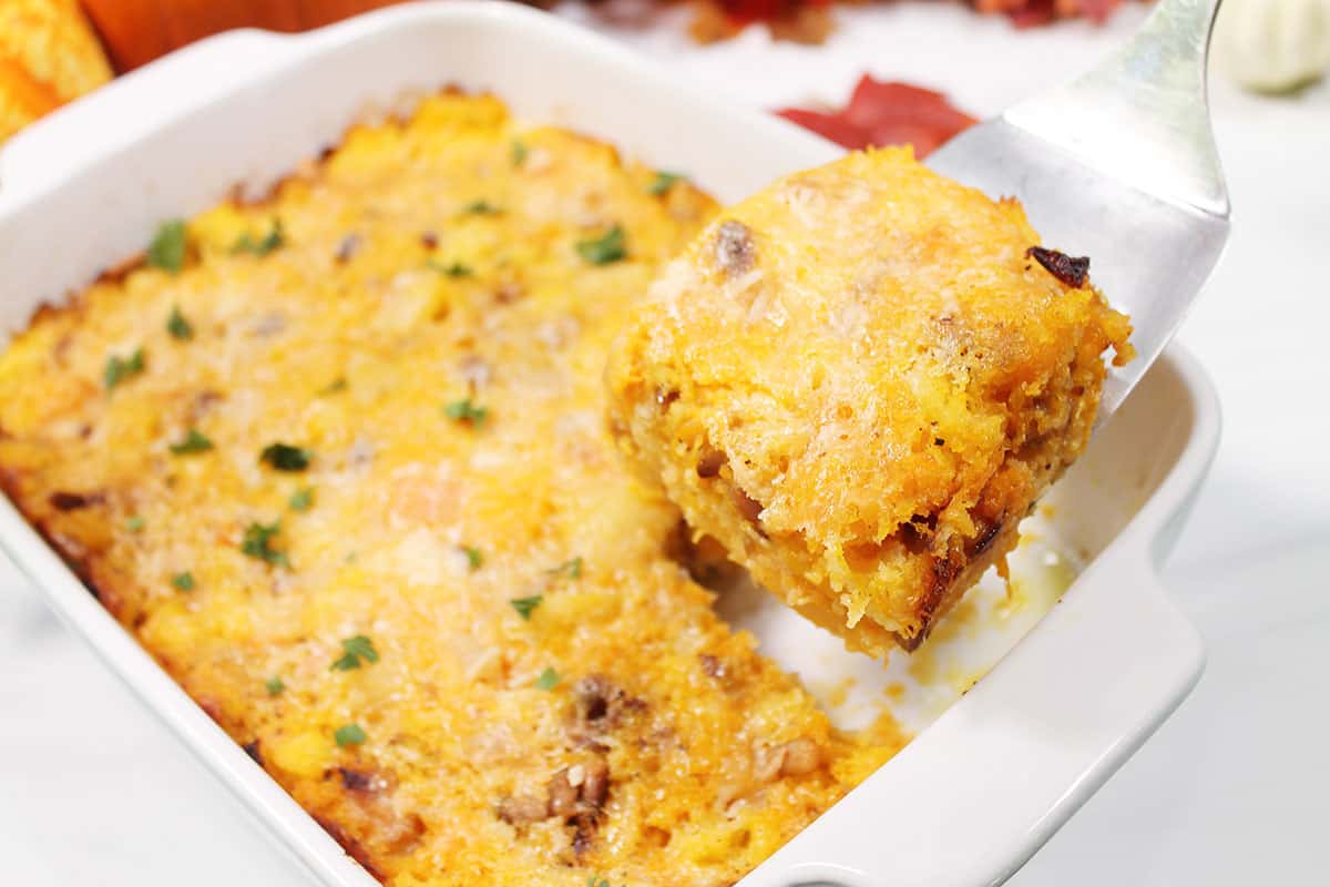 Lifting slice from casserole with spatula.