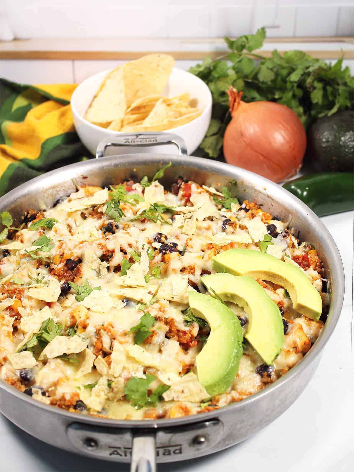 Baked Mexican Quinoa Casserole with garnishes of avocado and cilantro.