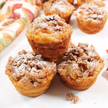 Three stacked muffins on fall table.