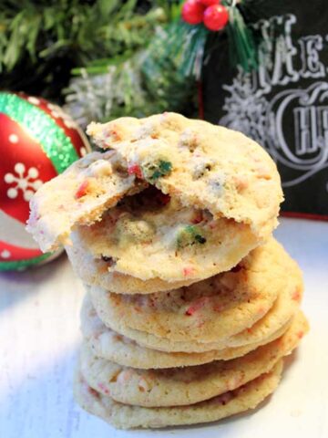 Stack of peppermint chip cookies with Merry Christmas in background.