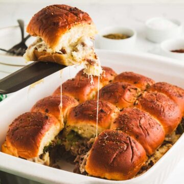 Lifting Philly cheesecake Slider out of dish.