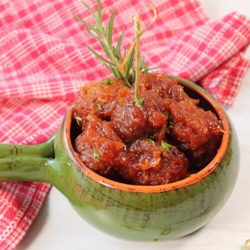 Cranberry Sauce Meatballs in green dish.
