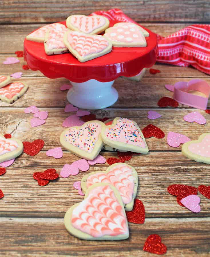 Sweet Heart Cookies on stand and scattered on wooden table