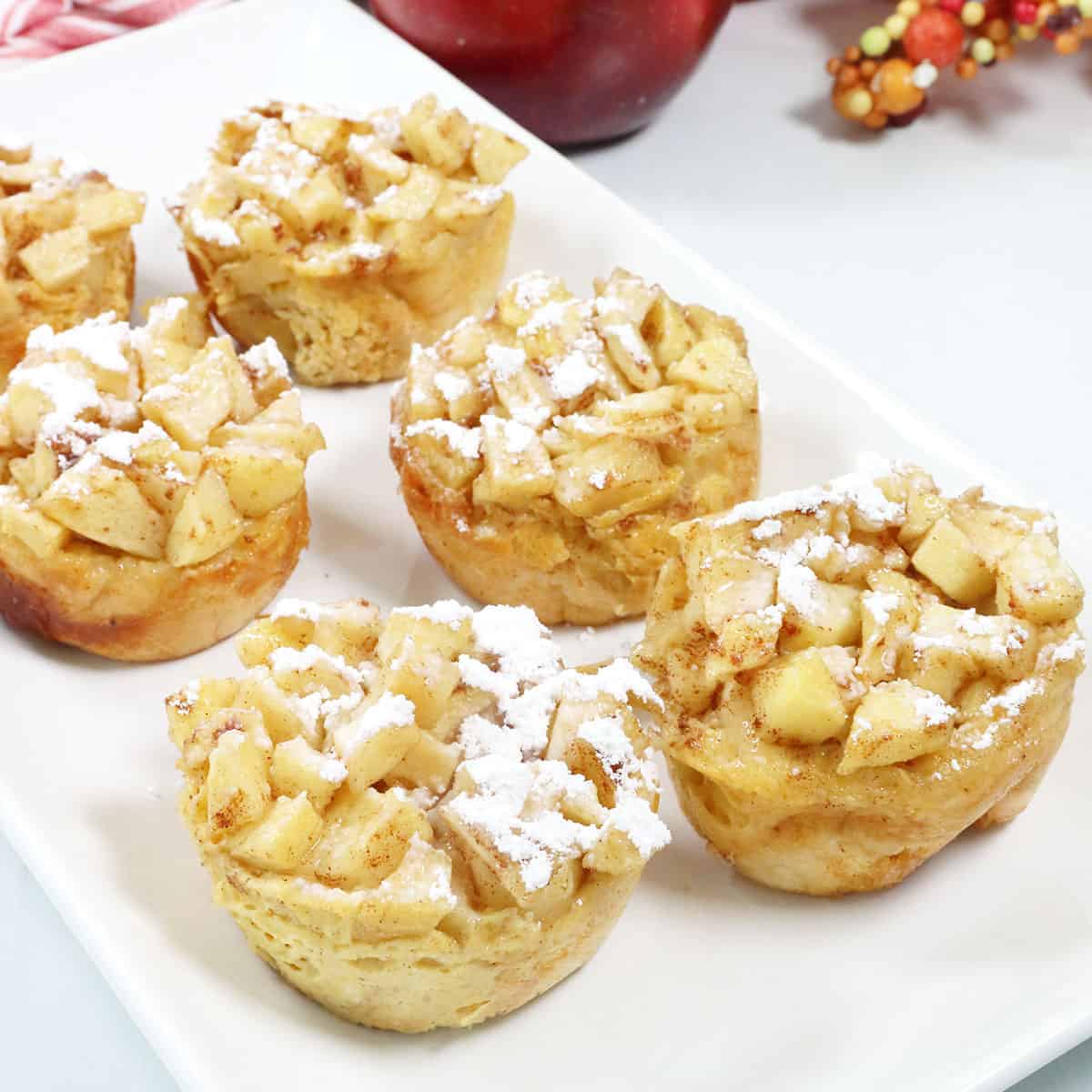Apple French Toast Muffins with powdered sugar.