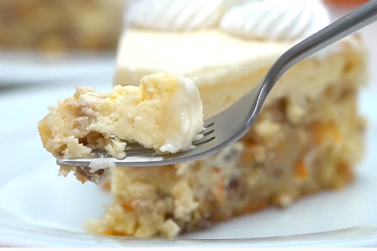 Bite of cheesecake on fork.
