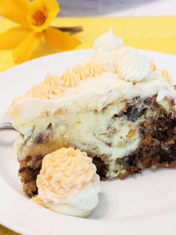 Closeup of Cheesecake Factory Carrot Cake Cheesecake slice with frosting.