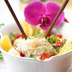 Closeup of bowl with chopsticks sticking out of noodles ready to eat.
